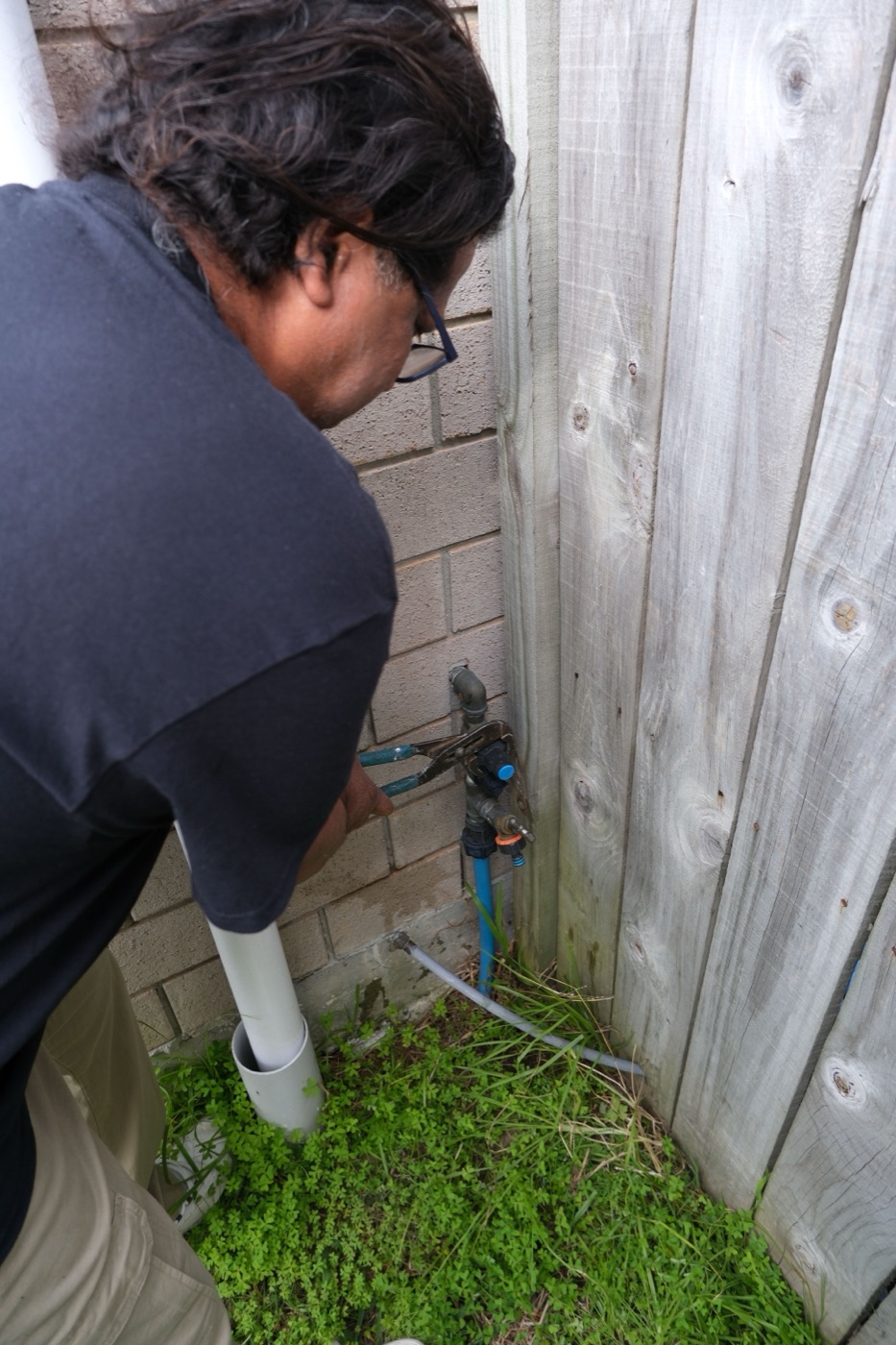 Savio repairing an outdoor tap